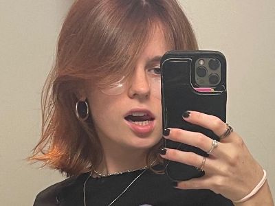 Wylie Quinn Anderson is wearing a black shirt with a necklace and shades as she is taking the selfie.